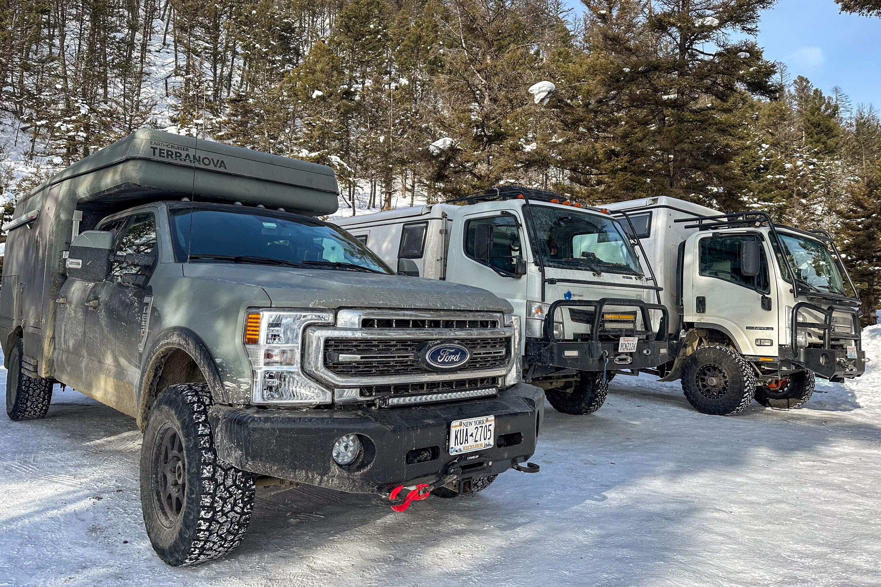 EarthCruiser trucks lineup in snow